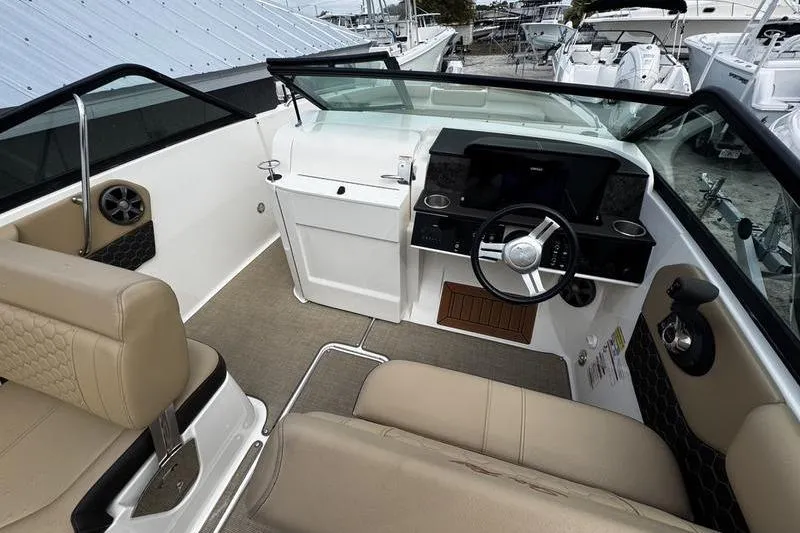 Slide: The Image of Interior view of 2019 Sea Ray SDX 250 boat with beige seating and modern dashboard. - 18