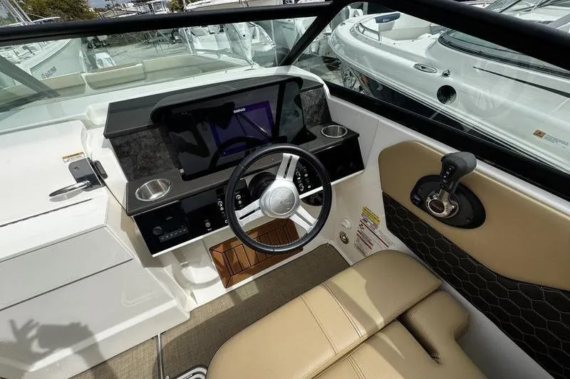 Slide: The Image of 2019 Sea Ray SDX 250 boat cockpit with steering wheel and control panel. - 19