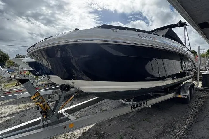 Slide: The Image of 2019 Sea Ray SDX 250 boat on trailer under cloudy sky. - 2