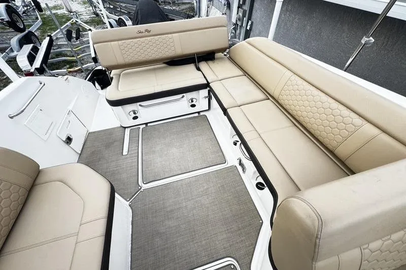 Slide: The Image of 2019 Sea Ray SDX 250 boat interior with beige seating and textured upholstery. - 20