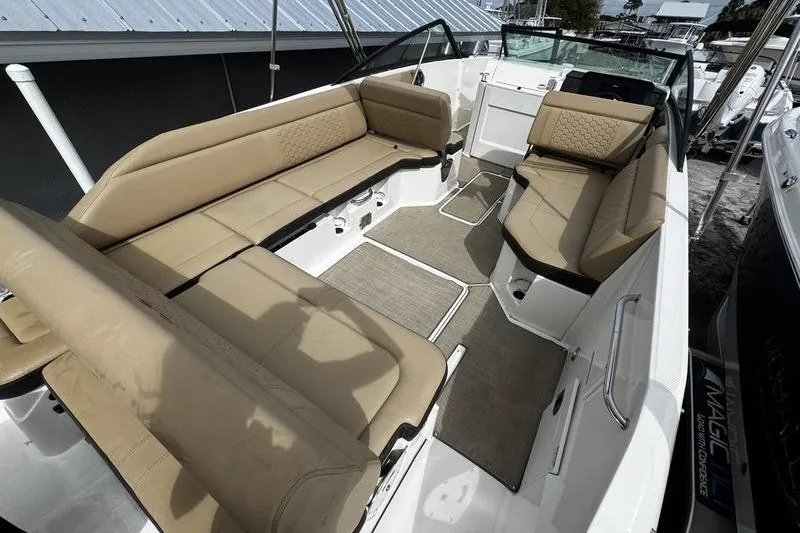 Slide: The Image of 2019 Sea Ray SDX 250 boat interior with beige seating and spacious layout. - 21