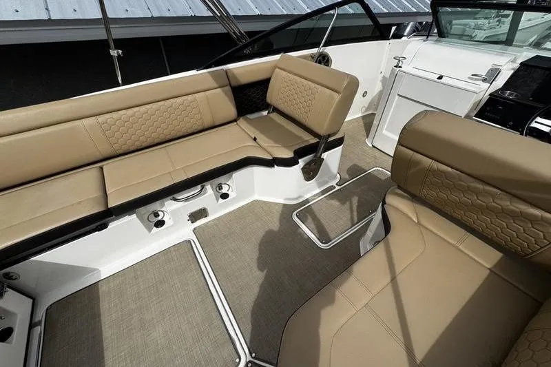 Slide: The Image of 2019 Sea Ray SDX 250 boat interior with tan seating and modern design. - 23