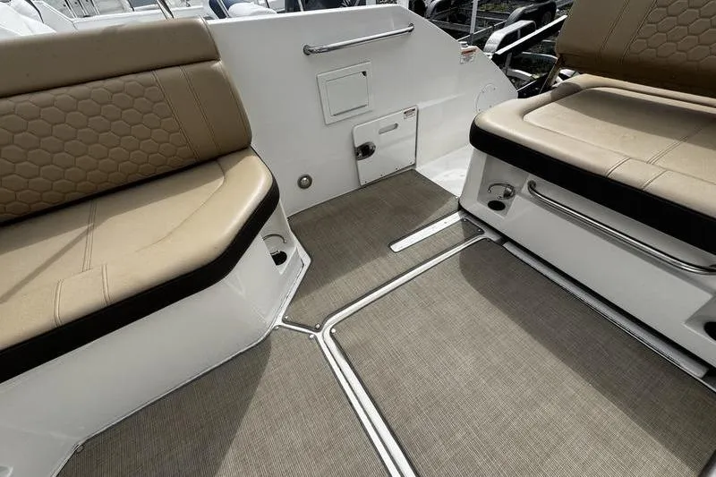 Slide: The Image of Interior seating of 2019 Sea Ray SDX 250 boat with beige cushions. - 25