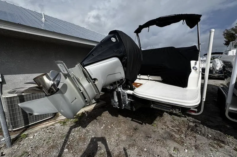 Slide: The Image of 2019 Sea Ray SDX 250 boat with covered outboard motor, parked outdoors. - 4