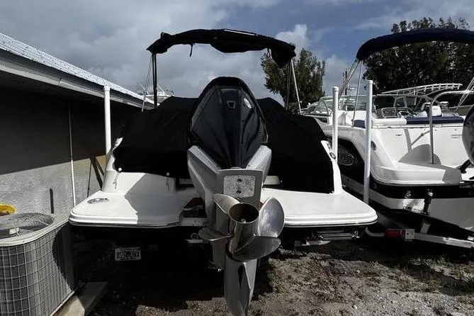 Slide: The Image of 2019 Sea Ray SDX 250 boat with covered engine, parked outdoors. - 5