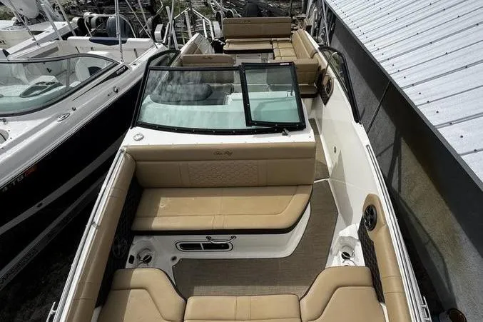 Slide: The Image of 2019 Sea Ray SDX 250 boat with tan seating and open deck layout. - 7