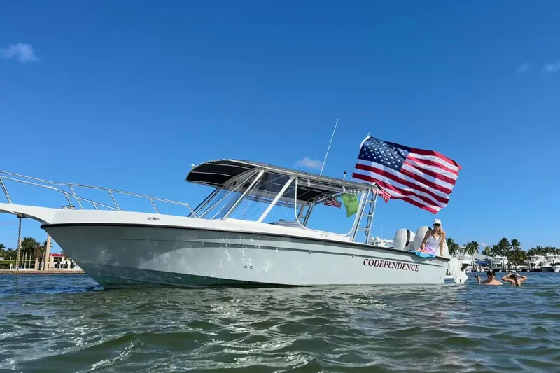 The Image of Boat named "Codependence" with American flag on water, Salt Shaker 300 model, 1990. - 0