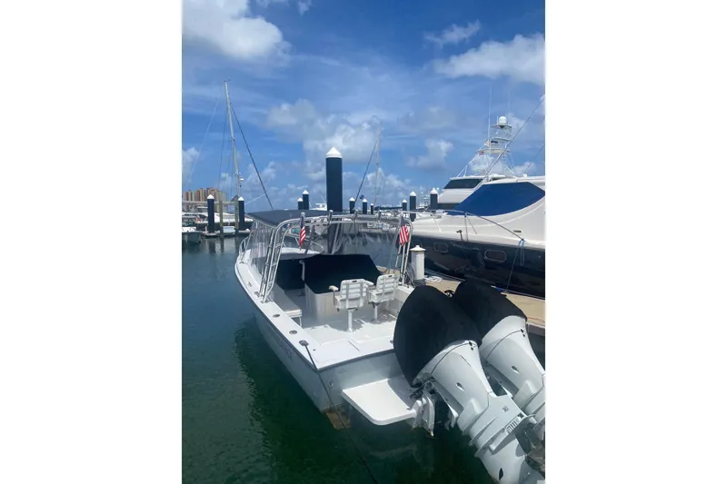 The Image of A 1990 Salt Shaker 300 boat docked at a marina under a clear blue sky. - 1