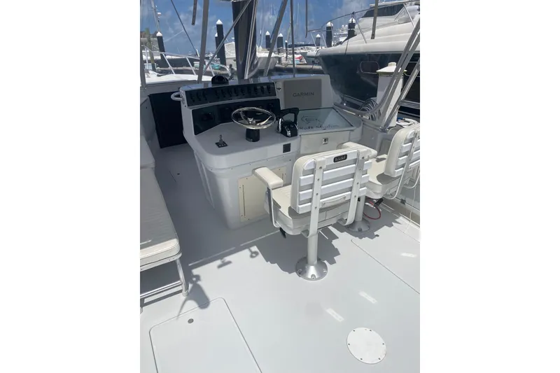 Slide: The Image of Cockpit of 1990 Salt Shaker 300 boat with steering wheel and seating. - 11