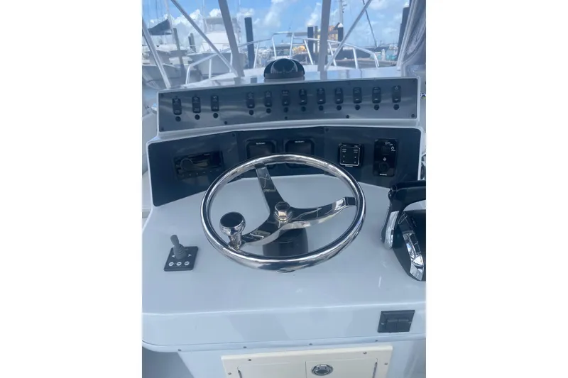 Slide: The Image of Boat steering console of 1990 Salt Shaker 300 with chrome wheel and controls. - 3