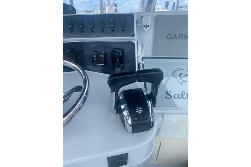 Slide: The Image of Boat control panel with steering wheel and throttle, Salt Shaker 300, 1990 model. - 4
