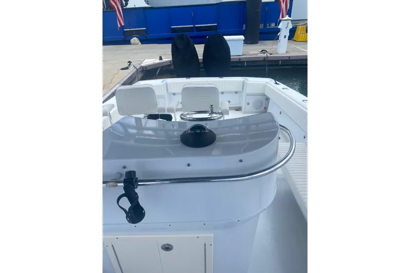 Slide: The Image of 1990 Salt Shaker 300 boat interior with white seating and control panel. - 9