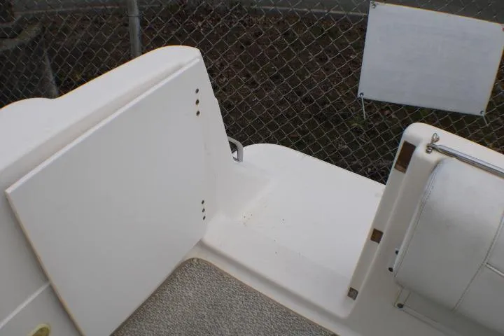 Slide: The Image of 1998 Bayliner 2655 Ciera Sunbridge boat interior with white seating and carpeted floor. - 16