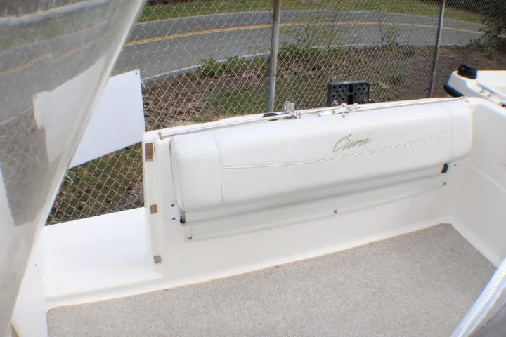 Slide: The Image of 1998 Bayliner 2655 Ciera Sunbridge boat interior with white seating and carpeted floor. - 17