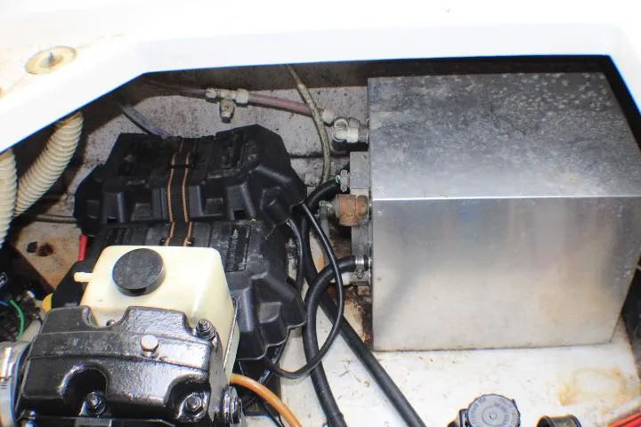 Slide: The Image of Engine compartment of a 1998 Bayliner 2655 Ciera Sunbridge, showing mechanical components and wiring. - 23