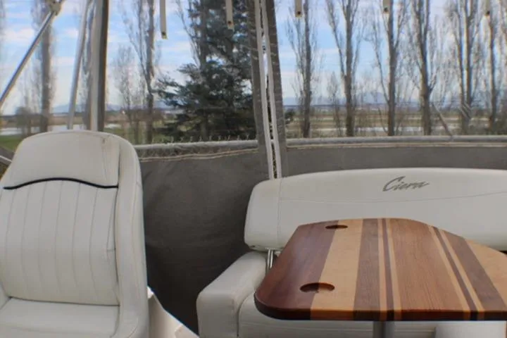 Slide: The Image of Interior of 1998 Bayliner 2655 Ciera Sunbridge with seating and wooden table. - 26