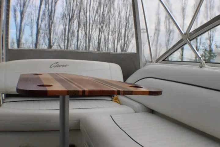 Slide: The Image of Interior of 1998 Bayliner 2655 Ciera Sunbridge with wooden table and white seating. - 29