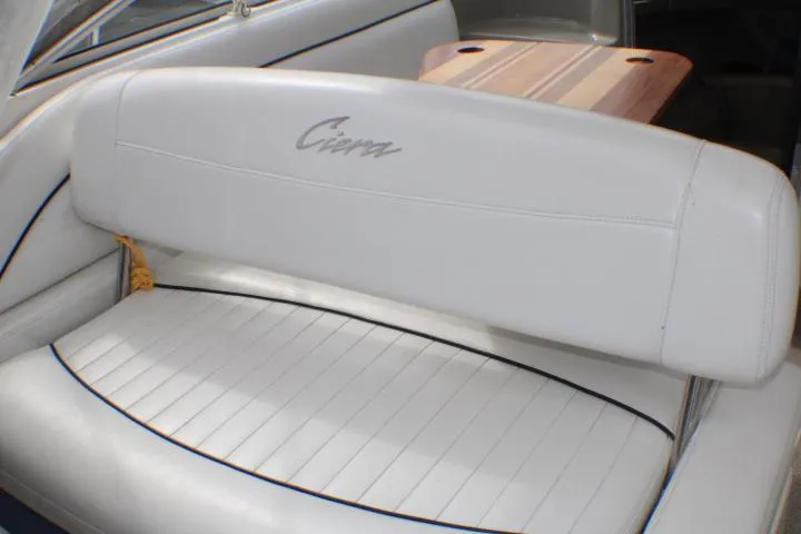 Slide: The Image of 1998 Bayliner 2655 Ciera Sunbridge interior with white seating and wooden table. - 31