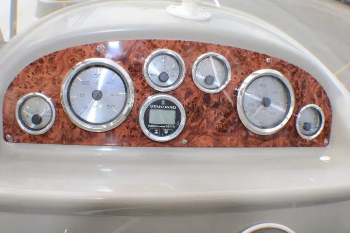 Slide: The Image of Dashboard of a 1998 Bayliner 2655 Ciera Sunbridge with wood paneling and gauges. - 33