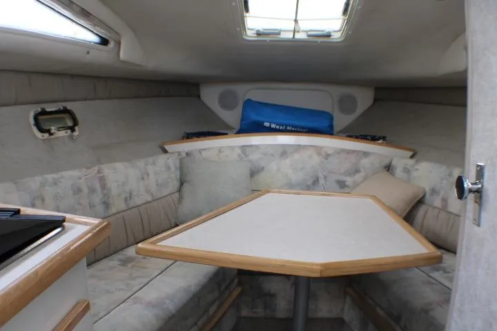 Slide: The Image of Interior of 1998 Bayliner 2655 Ciera Sunbridge with cozy seating and table. - 38