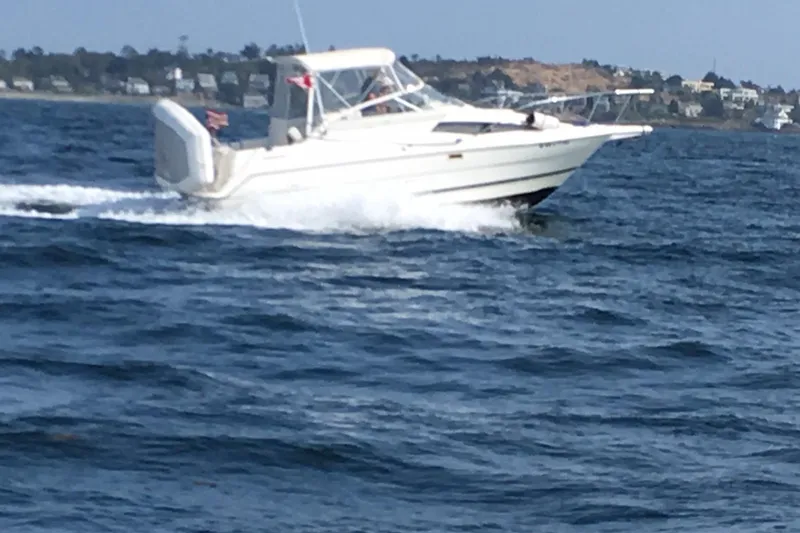 Slide: The Image of 1998 Bayliner 2655 Ciera Sunbridge cruising on open water. - 4