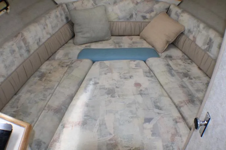 Slide: The Image of 1998 Bayliner 2655 Ciera Sunbridge cabin interior with cushioned seating and pillows. - 41