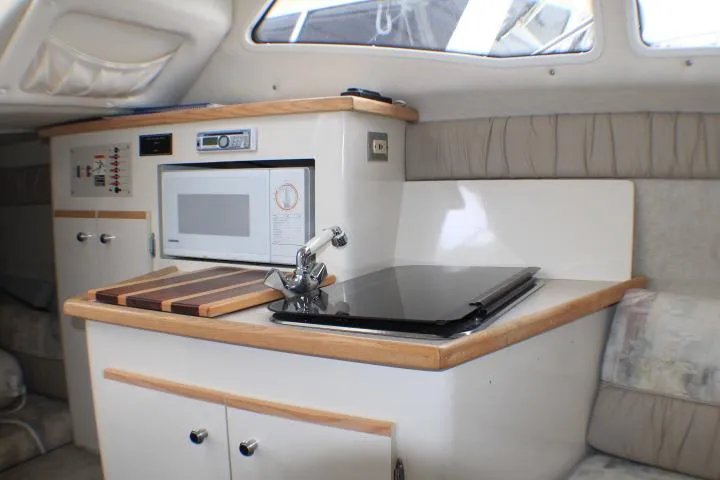 Slide: The Image of Interior of a 1998 Bayliner 2655 Ciera Sunbridge with kitchenette and microwave. - 42