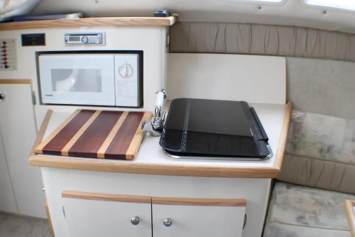 Slide: The Image of Interior of 1998 Bayliner 2655 Ciera Sunbridge with kitchenette and seating area. - 43