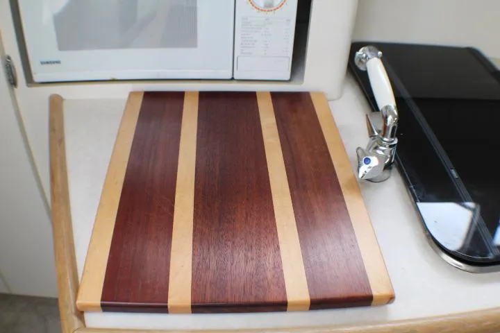 Slide: The Image of Cutting board on Bayliner 2655 Ciera Sunbridge 1998 kitchen counter, near microwave and faucet. - 44