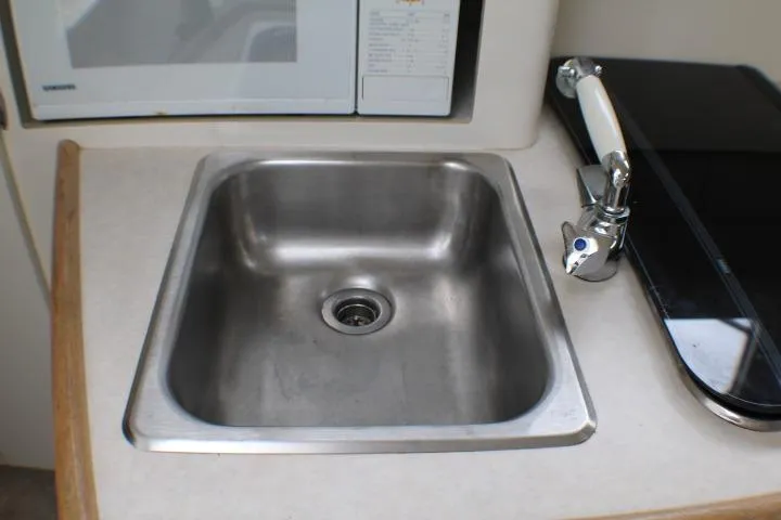 Slide: The Image of Stainless steel sink in 1998 Bayliner 2655 Ciera Sunbridge boat kitchen area. - 45