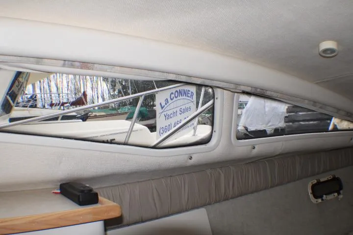 Slide: The Image of Interior view of 1998 Bayliner 2655 Ciera Sunbridge with yacht sales sign visible through window. - 49