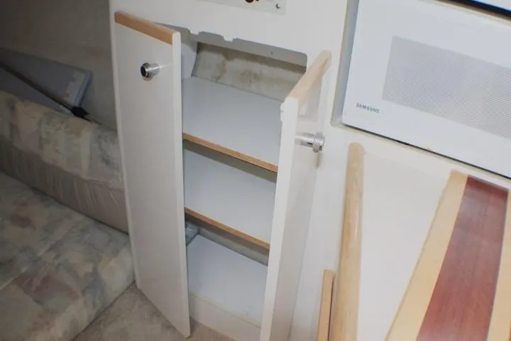 Slide: The Image of Open cabinet in 1998 Bayliner 2655 Ciera Sunbridge interior, showcasing storage space. - 51