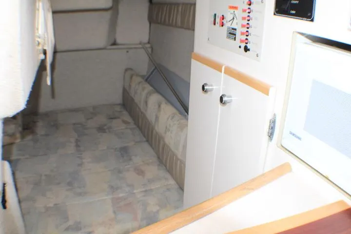 Slide: The Image of Interior cabin of 1998 Bayliner 2655 Ciera Sunbridge, featuring seating and control panel. - 53