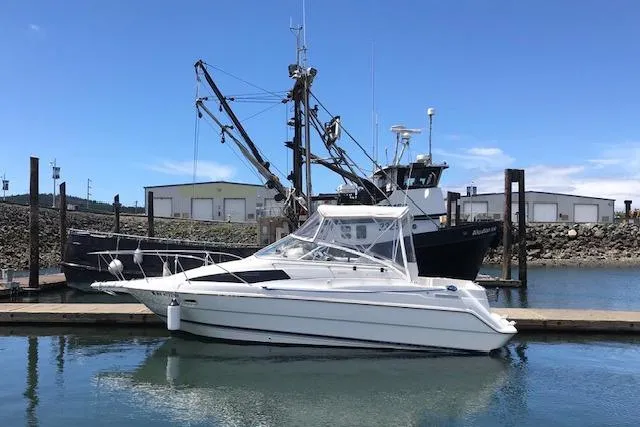 Slide: The Image of 1998 Bayliner 2655 Ciera Sunbridge docked at a marina under clear blue skies. - 6