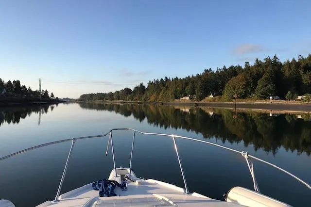 Slide: The Image of Bayliner 2655 Ciera Sunbridge cruising on a calm, scenic river, 1998 model. - 8