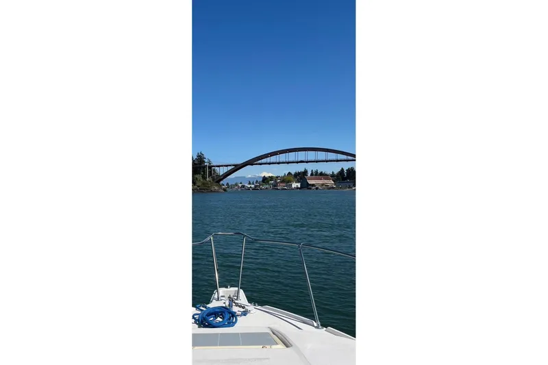 Slide: The Image of Bayliner 2655 Ciera Sunbridge cruising under a scenic bridge, 1998 model. - 9