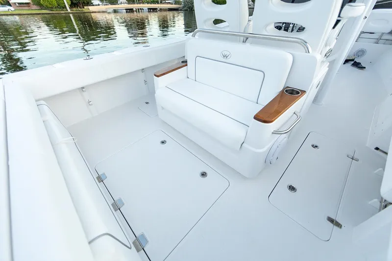 Slide: The Image of Manufacturer Provided Image: 2025 Southport 30 FE boat interior with white seating and wooden armrests. - 6