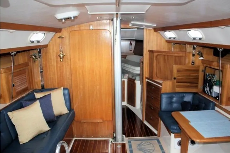 Slide: The Image of Interior of 2001 Catalina 36 MkII sailboat with wood paneling and cozy seating area. - 3