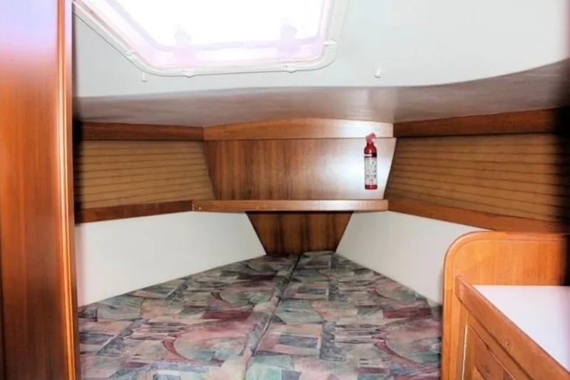 Slide: The Image of Interior cabin of 2001 Catalina 36 MkII sailboat with wooden finish and patterned bedding. - 5