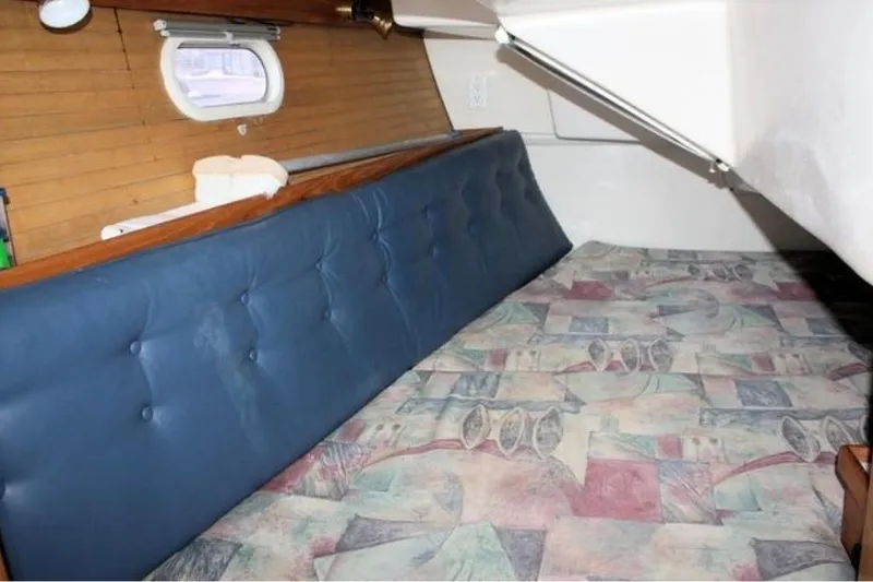 Slide: The Image of Interior cabin of 2001 Catalina 36 MkII sailboat with cushioned seating and patterned bedding. - 6