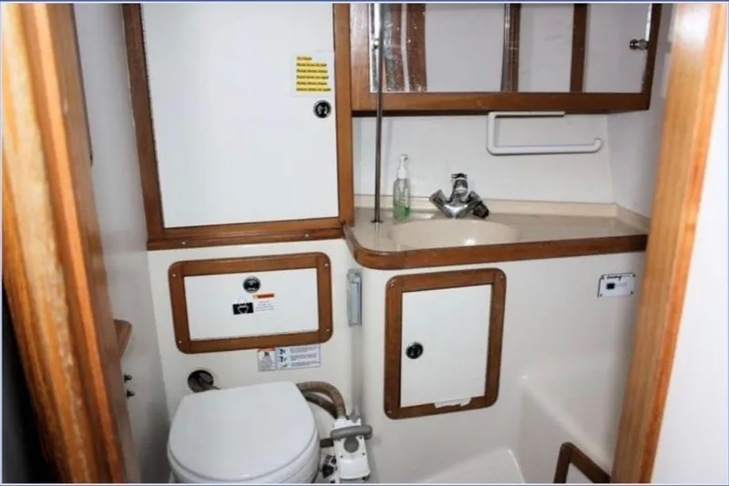 Slide: The Image of Bathroom interior of a 2001 Catalina 36 MkII sailboat, featuring sink and toilet. - 7