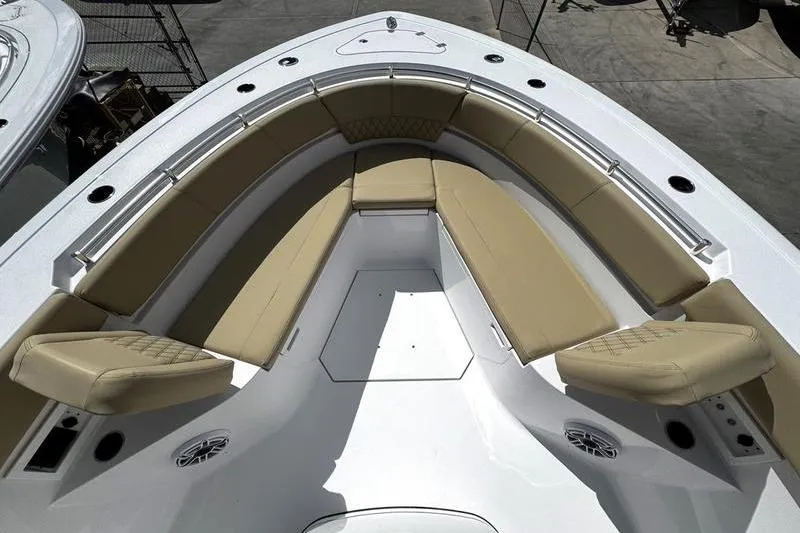 Slide: The Image of 2026 Sportsman Heritage 321 Center Console boat with open storage compartments and cushioned seating. - 11
