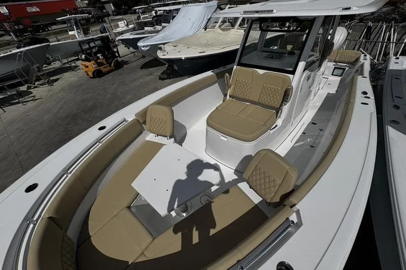 Slide: The Image of 2026 Sportsman Heritage 321 Center Console boat with tan cushioned seating. - 13