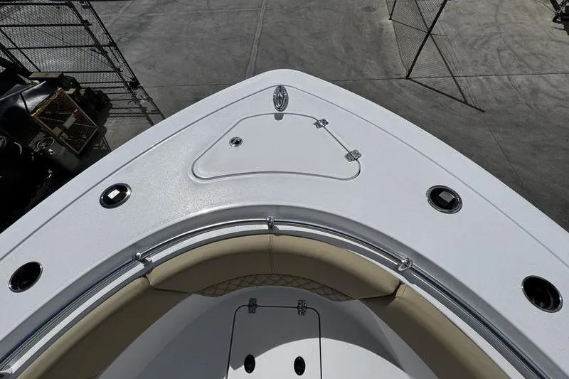 Slide: The Image of Open anchor compartment on 2026 Sportsman Heritage 321 Center Console boat. - 2