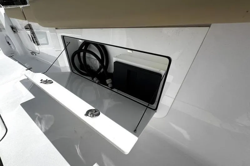 Slide: The Image of Storage compartment in 2026 Sportsman Heritage 321 Center Console boat, featuring hydraulic supports. - 21