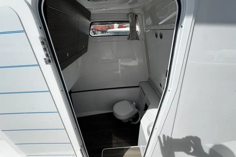 Slide: The Image of Open storage cabinet inside 2026 Sportsman Heritage 321 Center Console boat. - 22