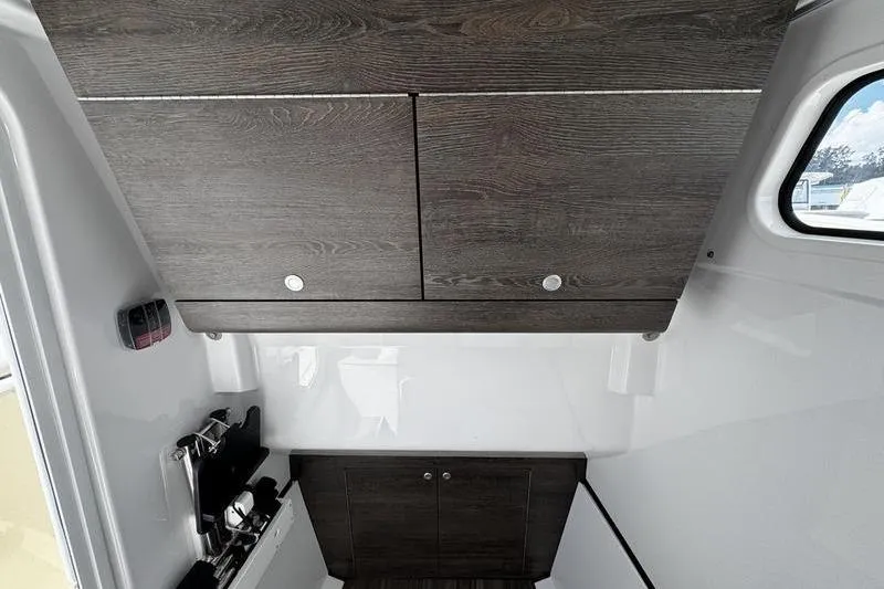 Slide: The Image of 2026 Sportsman Heritage 321 Center Console boat dashboard with steering wheel and controls. - 25