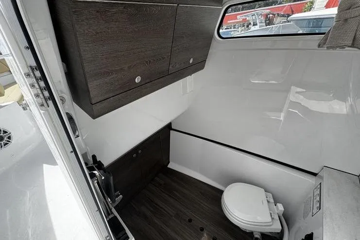 Slide: The Image of Center console of 2026 Sportsman Heritage 321 boat with steering wheel and controls. - 26