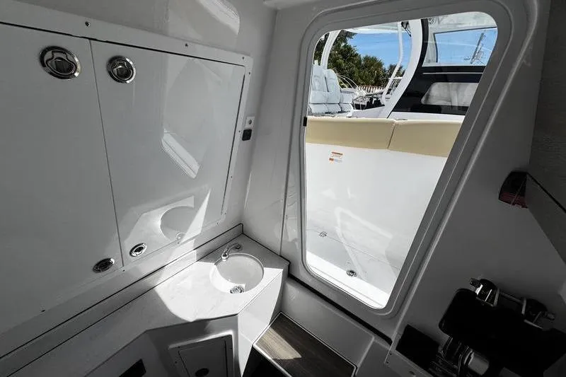Slide: The Image of Luxurious seating on 2026 Sportsman Heritage 321 Center Console boat, featuring plush, diamond-stitched upholstery. - 28
