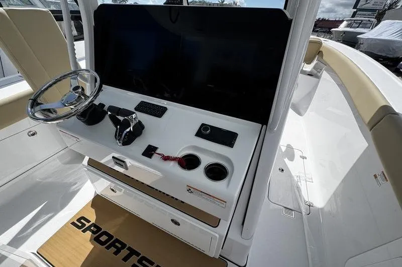 Slide: The Image of 2026 Sportsman Heritage 321 Center Console boat interior with tan seating and cup holders. - 30